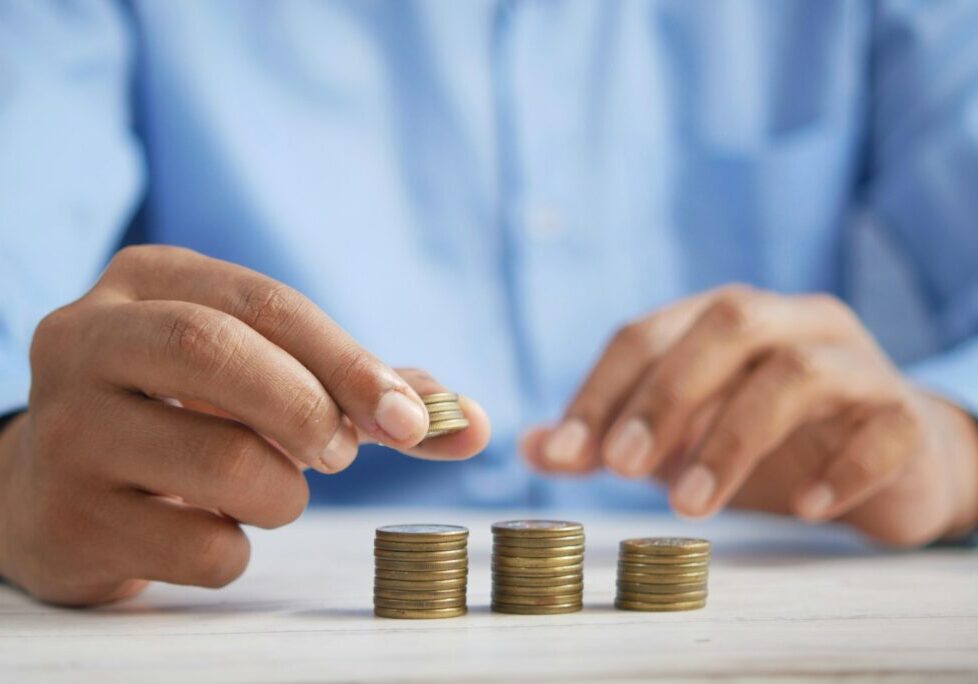 Hands stacking coins on a desk